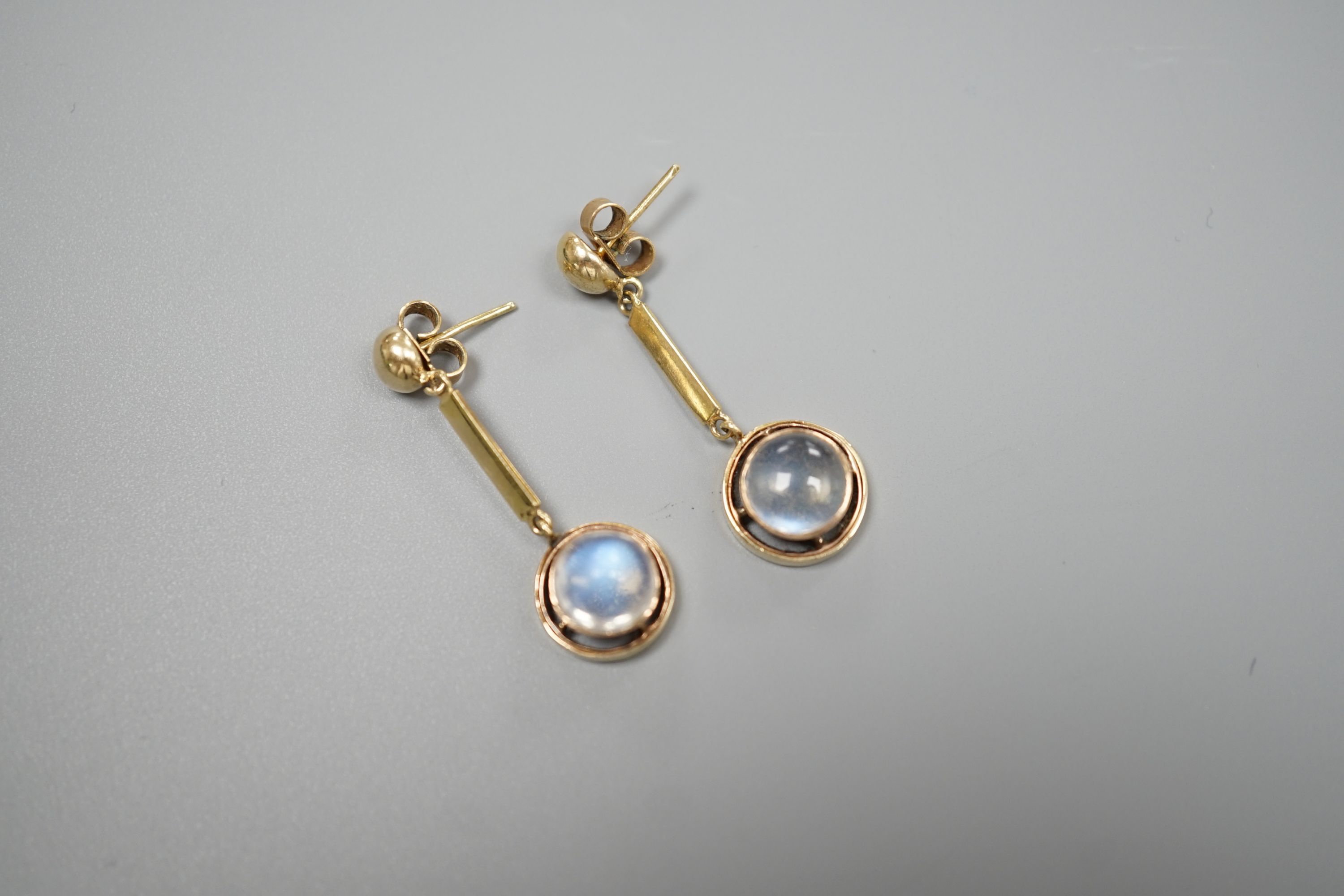 A pair of yellow metal and cabochon moonstone set drop earrings, 31mm, gross weight 4.8 grams.
